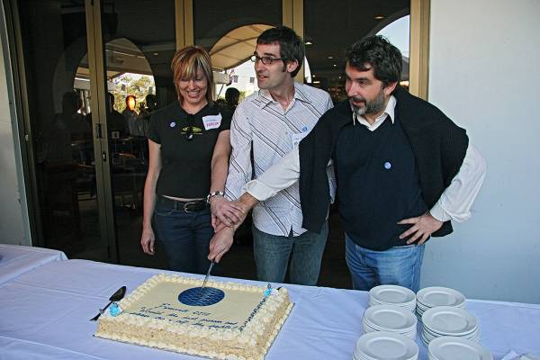 First staff cutting the cake,  | Naomi Andrew, Michael Lawley, Zoran Milosevic,  | DSTC Farewell Symposium, 28 July 2005  | 