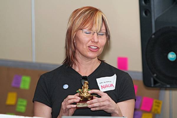Naomi Andrew, appreciating the texture of this beautiful statuette prize,  | DSTC Farewell Symposium, 28 July 2005  | 